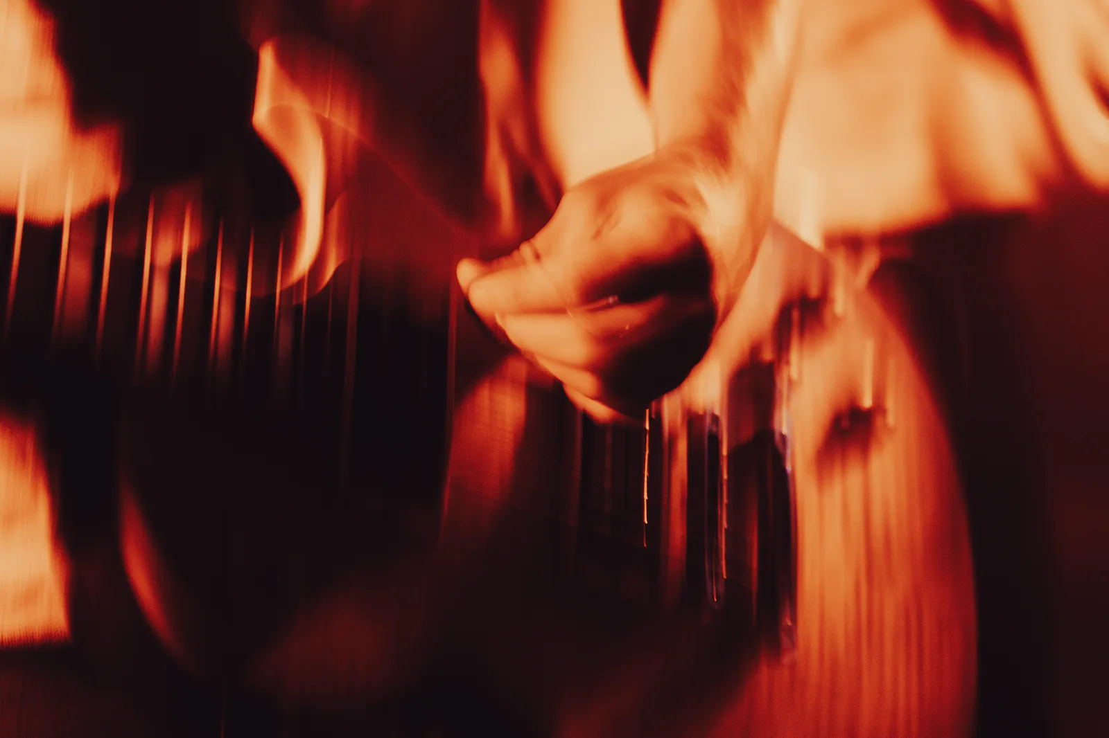 close-up of a guitarist performing at bar freda